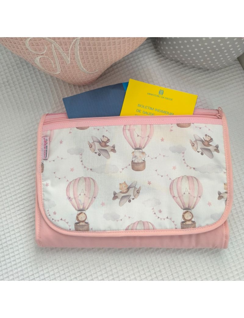 Bolsa multiusos fechada com uma bolsa frontal. Padrão de balões de ar quente em tons de rosa e aviões em tons de cinza e creme . Fecho zíper rosa